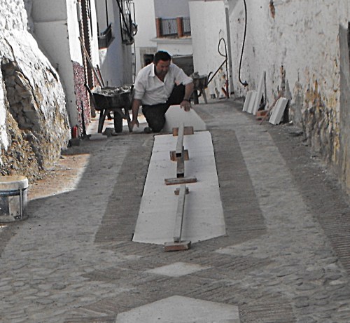 Here is the gaffer checking the levels after the central concrete slab has been put in place. Actually that slab had to be turned over because the elderly ladies went ar*e over t*t on the marble every time it rained. So the rough surface was put uppermost