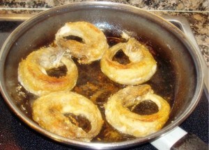 Pescadilla or young Hake. The sharp little teeth are clamped onto the tail in this "classic" fried fish dish