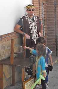 Moorish Dad watching Moorish kids playing wooden street game